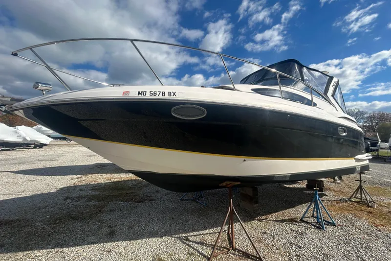 The Image of 2007 Regal 3060 Express Cruiser on stands, under a partly cloudy sky. - 1