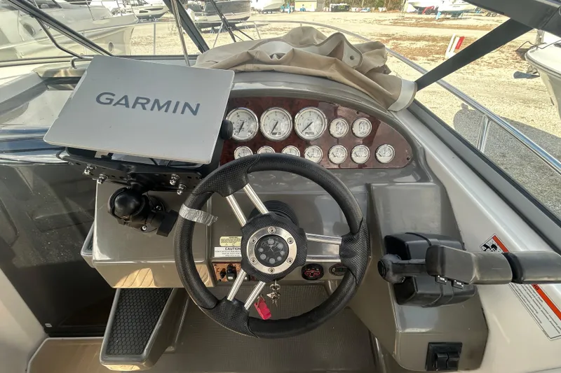 Slide: The Image of 2007 Regal 3060 Express Cruiser dashboard with Garmin navigation and steering wheel. - 14