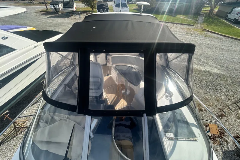 Slide: The Image of 2007 Regal 3060 Express Cruiser with black canopy, docked in a marina. - 3