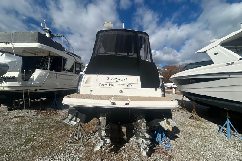 Slide: The Image of 2007 Regal 3060 Express Cruiser on stands, Severn River, MD, under a cloudy sky. - 6