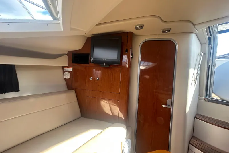 Slide: The Image of Interior of 2007 Regal 3060 Express Cruiser with TV and wooden cabinetry. - 8