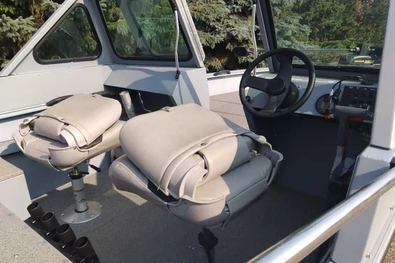 Slide: The Image of Interior of 2015 G3 Guide V177 WT boat with steering wheel and cushioned seats. - 14