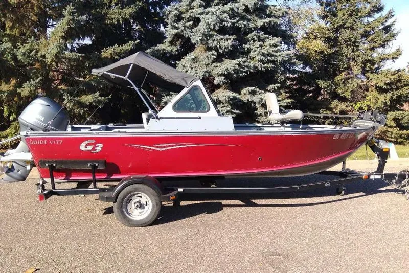 Slide: The Image of 2015 G3 Guide V177 WT boat on trailer, red exterior, parked outdoors. - 7