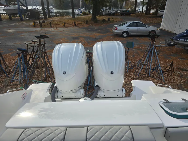 Slide: The Image of 2025 Pursuit S 288 boat with dual outboard engines in a marina setting. - 22