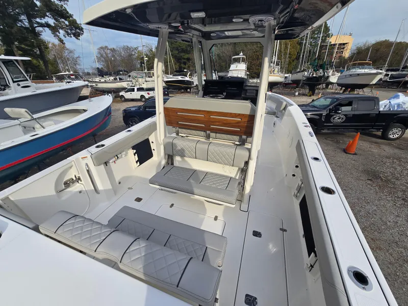 Slide: The Image of 2025 Pursuit S 288 boat interior with seating and helm, docked among other boats. - 25
