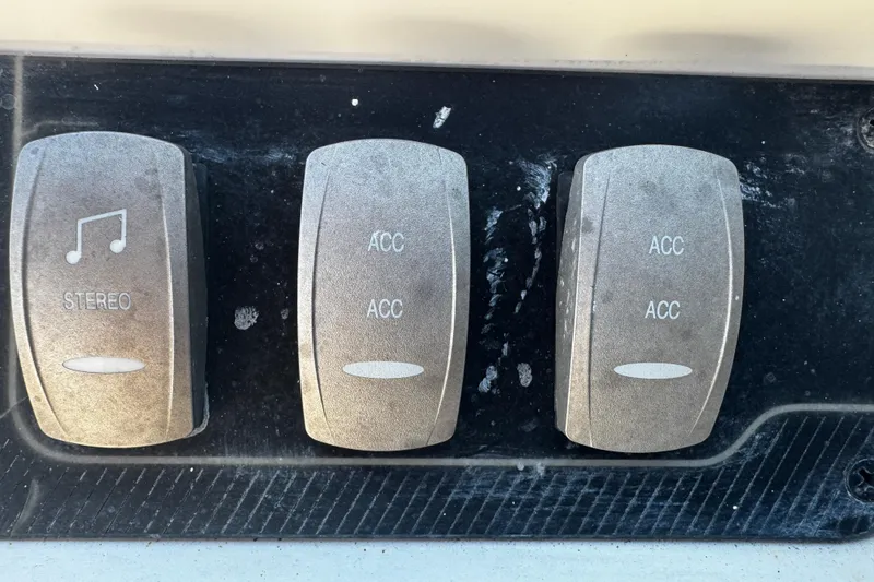 Slide: The Image of Control panel of a 2019 Hurricane SunDeck 2690 OB boat with stereo and accessory switches. - 10