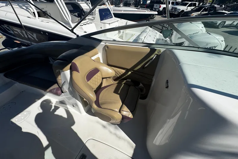 Slide: The Image of 2019 Hurricane SunDeck 2690 OB boat interior with tan seating and windshield. - 12