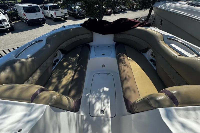 Slide: The Image of 2019 Hurricane SunDeck 2690 OB boat interior with cushioned seating and storage compartments. - 14