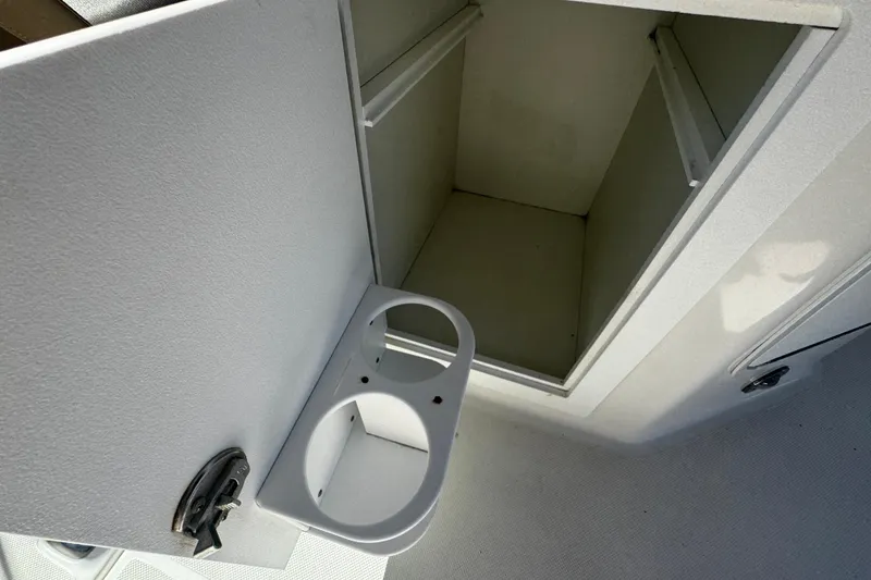 Slide: The Image of Open storage compartment with cup holders on 2019 Hurricane SunDeck 2690 OB boat. - 18