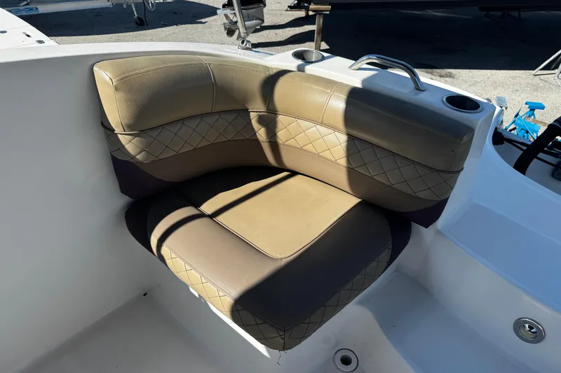Slide: The Image of 2019 Hurricane SunDeck 2690 OB boat seating with tan upholstery and cup holders. - 20