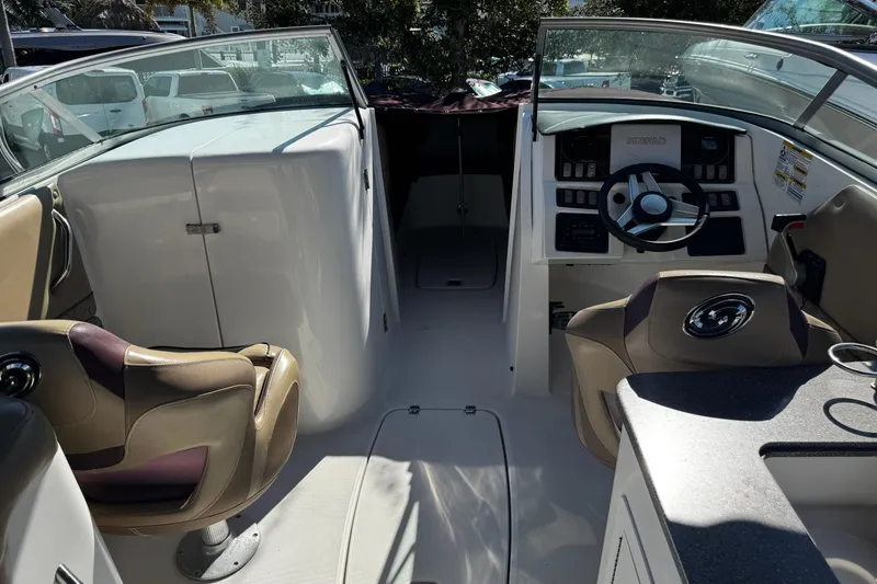 Slide: The Image of 2019 Hurricane SunDeck 2690 OB boat interior with steering wheel and seating. - 22