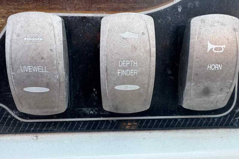 Slide: The Image of Control panel switches on a 2019 Hurricane SunDeck 2690 OB boat. - 8