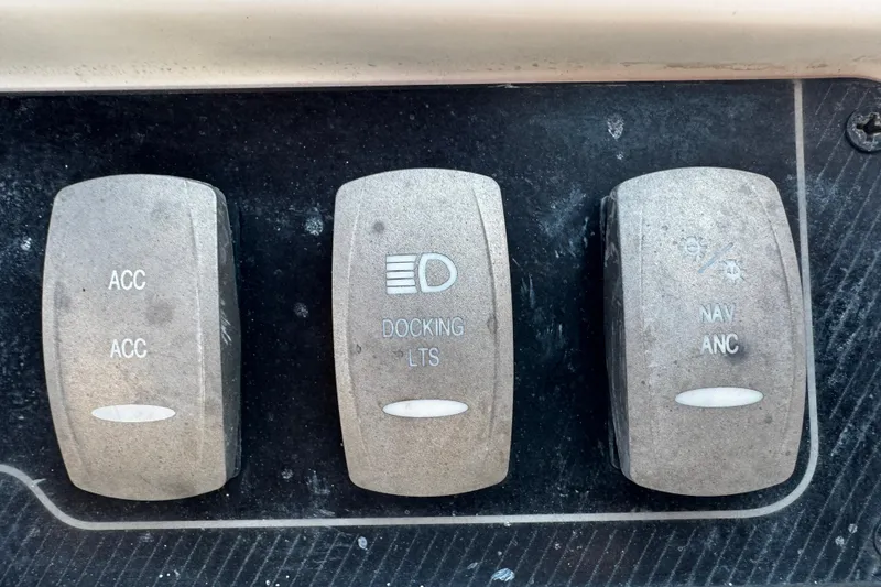 Slide: The Image of Control panel switches on a 2019 Hurricane SunDeck 2690 OB boat. - 9