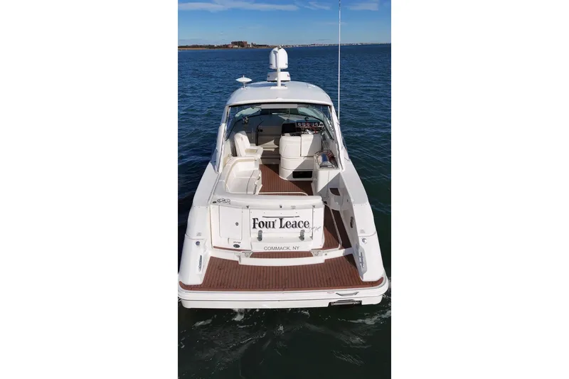 Slide: The Image of 2010 Sea Ray 370 Sundancer yacht on water, rear view, with open deck and seating. - 10