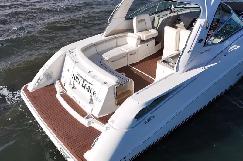 Slide: The Image of 2010 Sea Ray 370 Sundancer yacht on water, featuring spacious deck and seating area. - 12