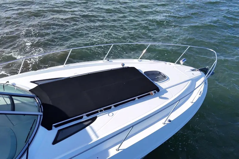 Slide: The Image of 2010 Sea Ray 370 Sundancer yacht on open water, featuring sleek design and sunpad. - 15