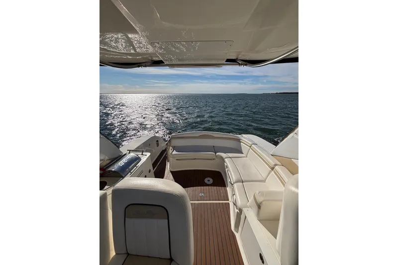 Slide: The Image of 2010 Sea Ray 370 Sundancer yacht interior with ocean view, featuring luxurious seating. - 17