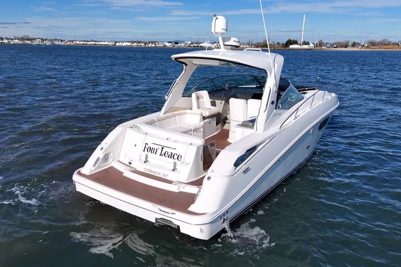 Slide: The Image of 2010 Sea Ray 370 Sundancer yacht on open water, rear view. - 2