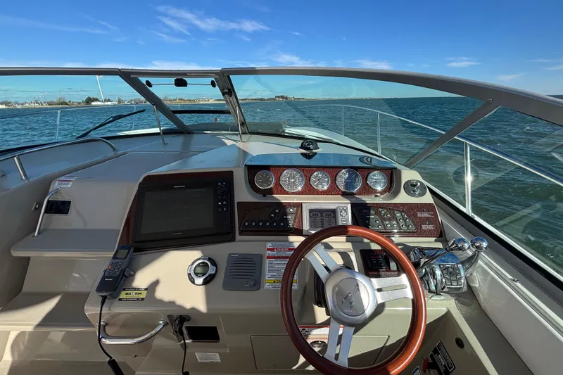 Slide: The Image of Cockpit view of 2010 Sea Ray 370 Sundancer boat with steering wheel and control panel. - 26
