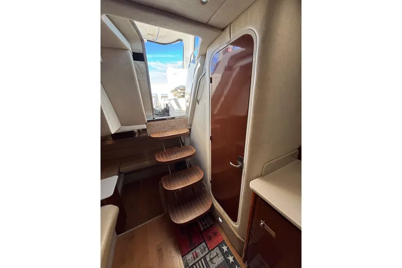 Slide: The Image of Interior of 2010 Sea Ray 370 Sundancer with wooden steps and modern design. - 29
