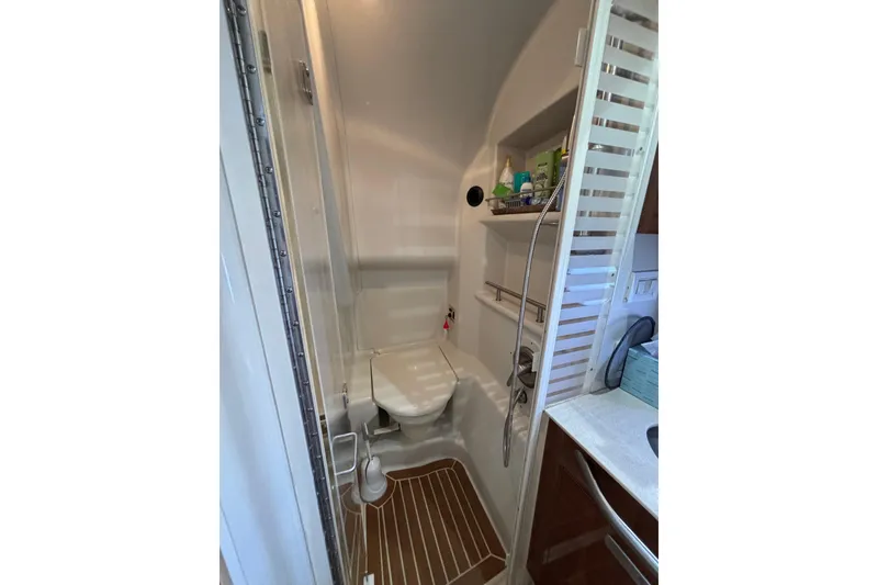 Slide: The Image of Compact bathroom in 2010 Sea Ray 370 Sundancer yacht with shower and storage shelves. - 30