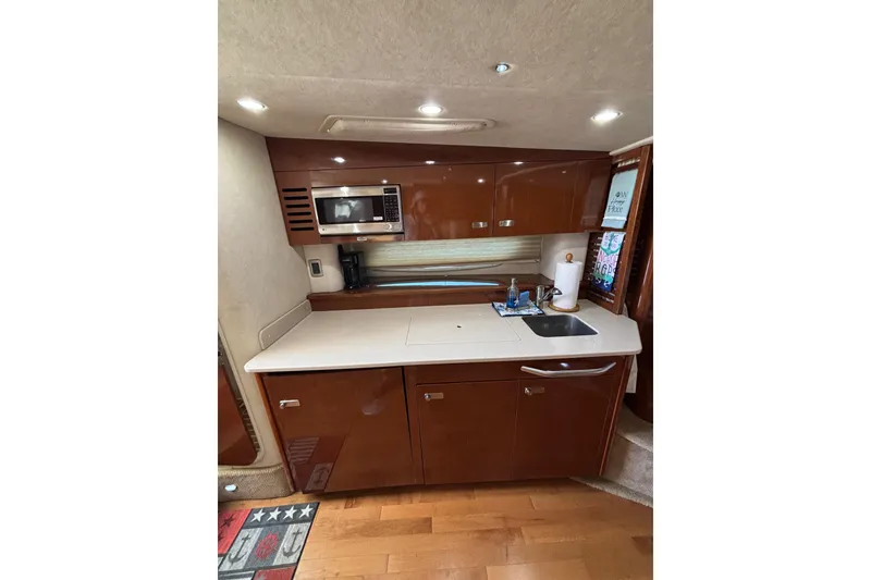 Slide: The Image of Interior of 2010 Sea Ray 370 Sundancer yacht kitchen with modern amenities. - 35