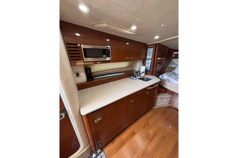 Slide: The Image of Interior of 2010 Sea Ray 370 Sundancer yacht with modern kitchen amenities. - 37