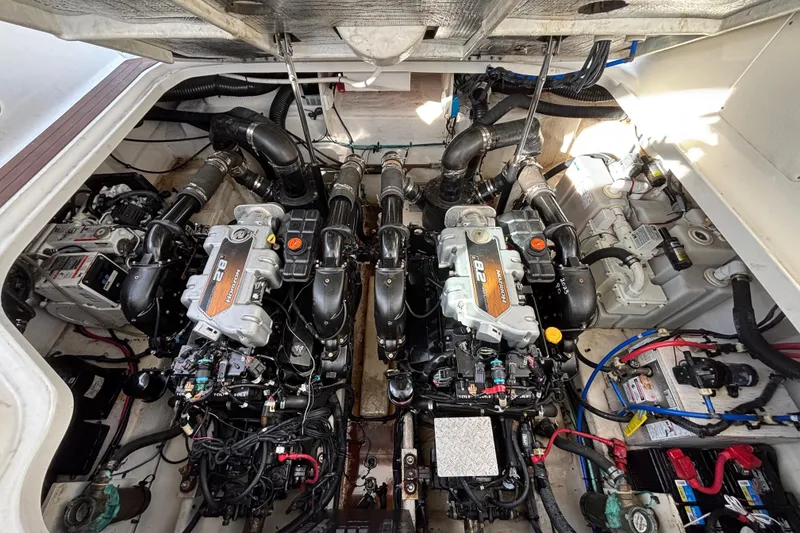 Slide: The Image of Engine compartment of a 2010 Sea Ray 370 Sundancer with dual engines and mechanical components. - 43