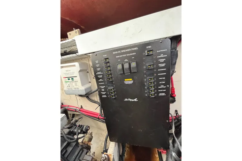 Slide: The Image of Main breaker panel on 2010 Sea Ray 370 Sundancer boat, featuring various electrical controls. - 48