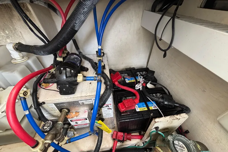Slide: The Image of Engine compartment of a 2010 Sea Ray 370 Sundancer with batteries and wiring. - 49