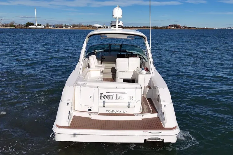 Slide: The Image of 2010 Sea Ray 370 Sundancer yacht on open water, rear view, clear sky. - 5