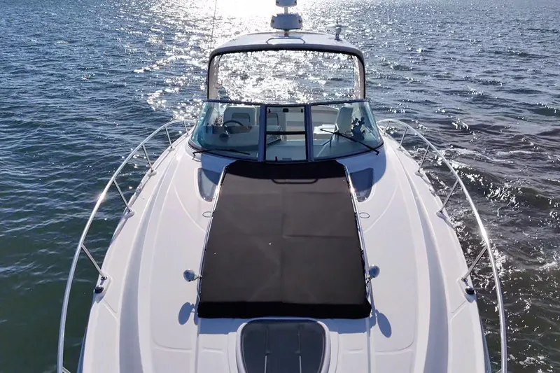 Slide: The Image of 2010 Sea Ray 370 Sundancer cruising on sparkling water. - 7