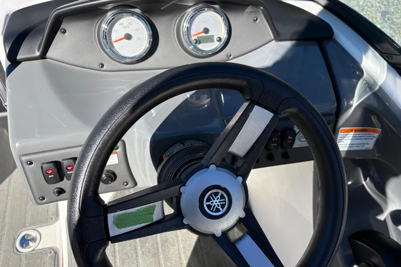 Slide: The Image of Steering wheel and dashboard of a 2018 Yamaha SX190 boat, featuring gauges and controls. - 11