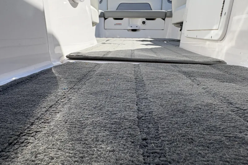 Slide: The Image of 2018 Yamaha SX190 boat interior with gray carpet flooring. - 13