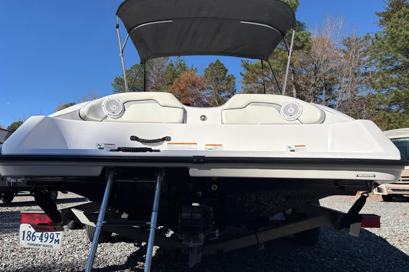 Slide: The Image of 2018 Yamaha SX190 boat with canopy, rear view, parked on trailer. - 8