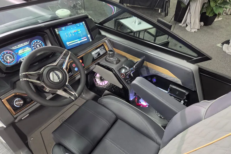 Slide: The Image of 2026 Godfrey Sanpan 2700 SBW Twin boat cockpit with modern steering and digital displays. - 18