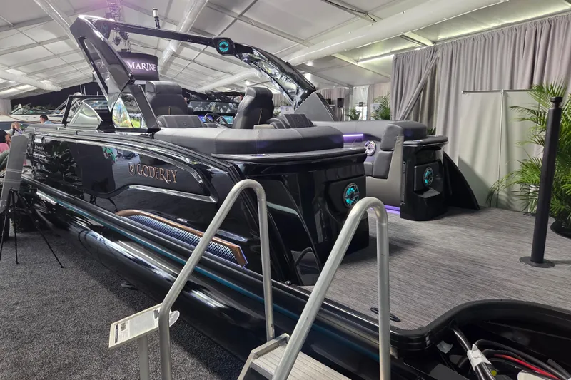 Slide: The Image of 2026 Godfrey Sanpan 2700 SBW Twin luxury pontoon boat displayed indoors. - 7
