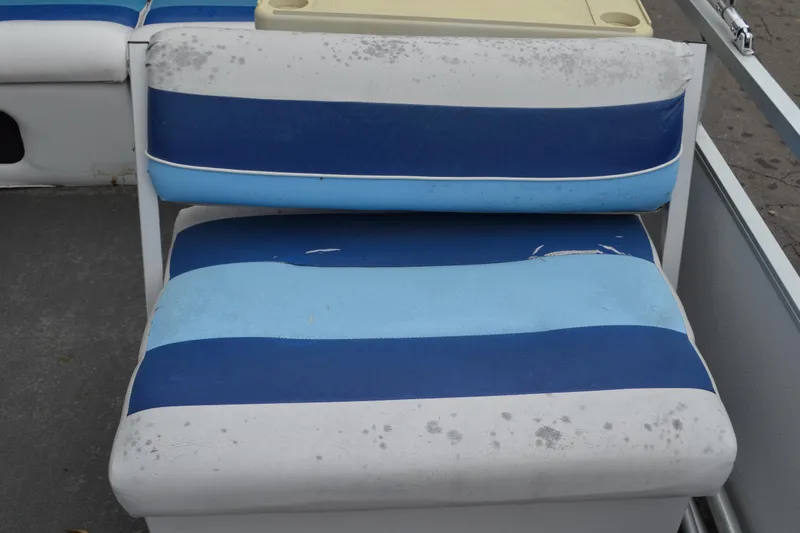 Slide: The Image of Worn blue and white seat on a 1992 Manitou SPORT boat. - 10