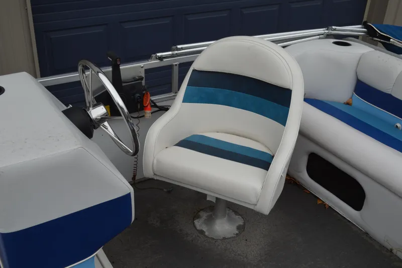 Slide: The Image of 1992 Manitou SPORT boat interior with blue and white seating and steering wheel. - 12