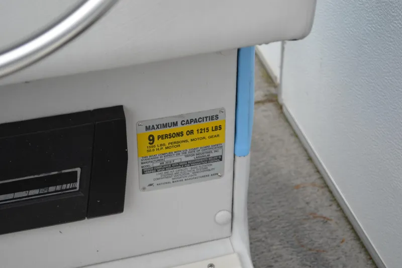 Slide: The Image of 1992 Manitou SPORT boat capacity label, maximum 9 persons or 1215 lbs. - 16