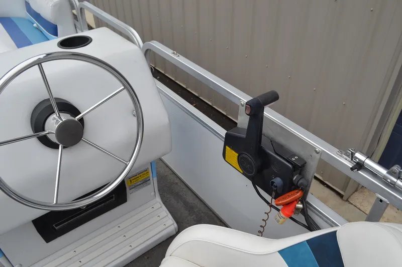 Slide: The Image of 1992 Manitou SPORT boat steering wheel and throttle control in a sleek interior. - 17