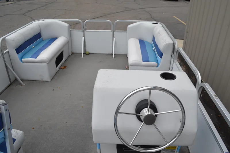 Slide: The Image of 1992 Manitou SPORT boat interior with steering wheel and blue-white seating. - 18