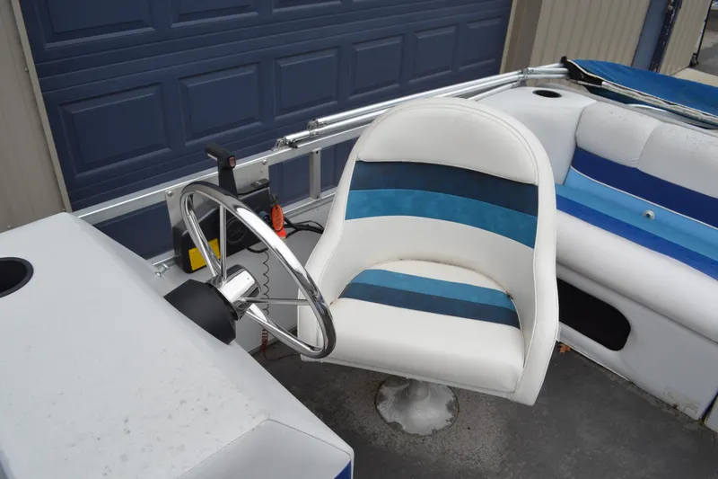 Slide: The Image of 1992 Manitou SPORT boat interior with blue and white seating and steering wheel. - 19