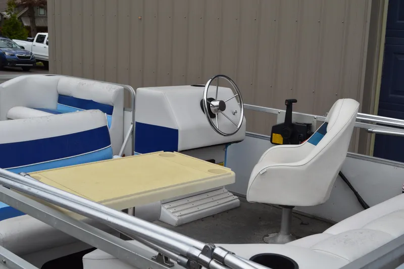 Slide: The Image of 1992 Manitou SPORT boat interior with steering wheel, seating, and table. - 22