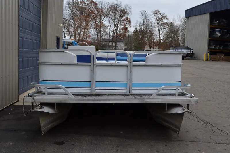 Slide: The Image of 1992 Manitou SPORT pontoon boat parked outside a warehouse. - 3