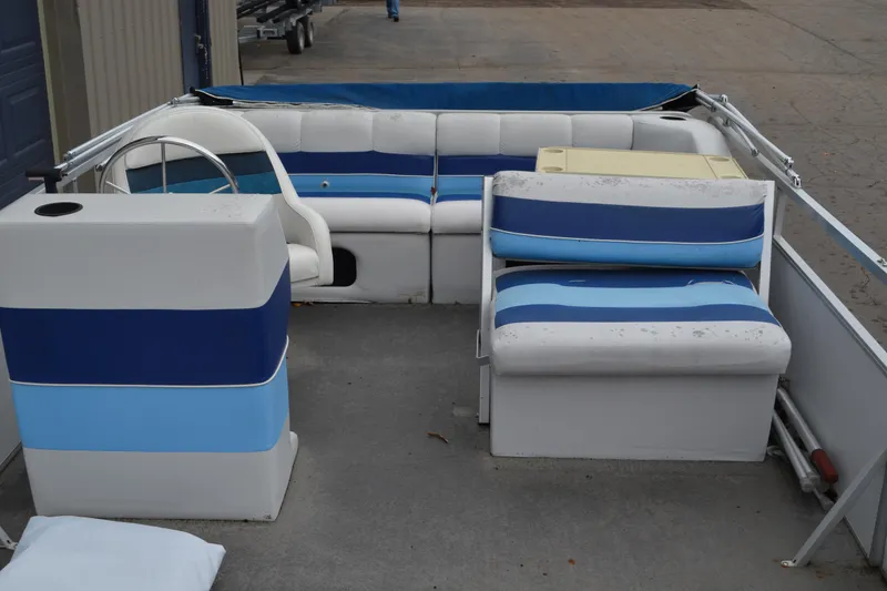 Slide: The Image of 1992 Manitou SPORT pontoon boat interior with blue and white seating arrangement. - 6