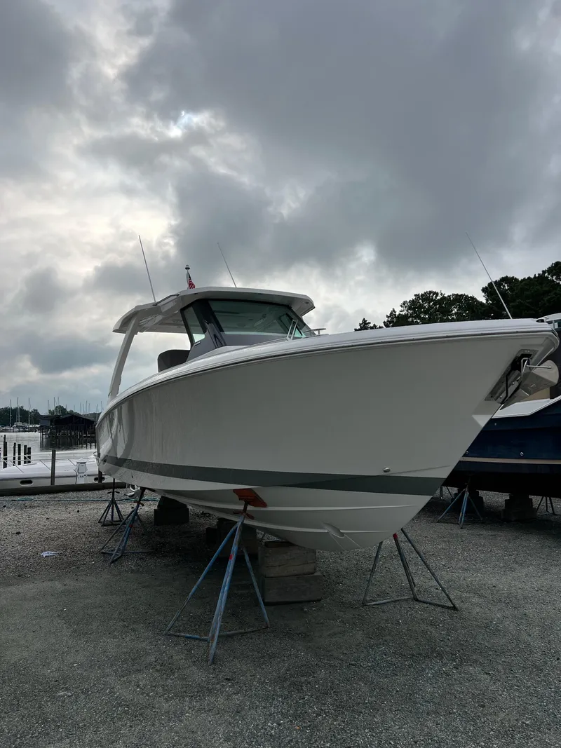 The Image of 2026 Tiara Yachts 34 LS on stands under cloudy sky. - 0