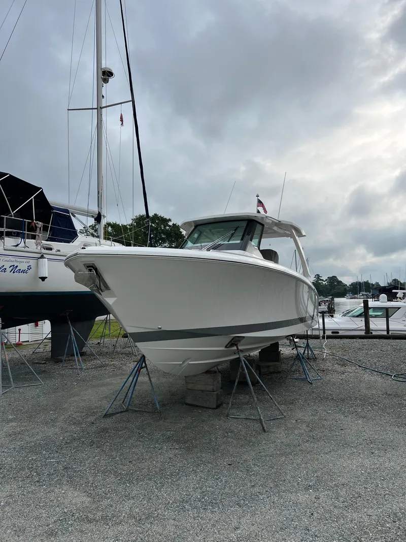 Slide: The Image of 2026 Tiara Yachts 34 LS boat on stands in a marina setting. - 1