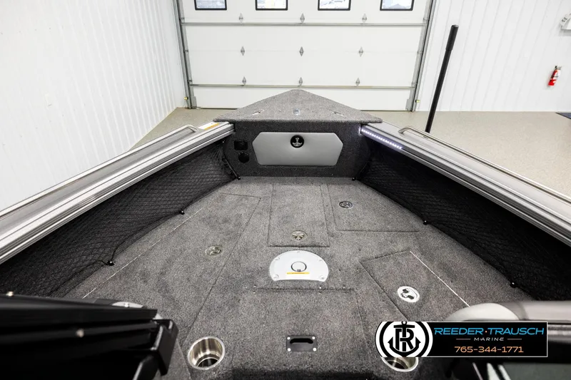 Slide: The Image of Interior view of 2026 Lund 1975 Tyee boat, featuring carpeted deck and storage compartments. - 14