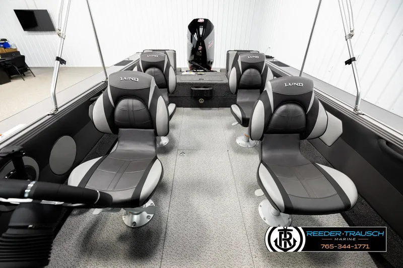 Slide: The Image of Interior of 2026 Lund 1975 Tyee boat with four gray seats and steering wheel. - 17